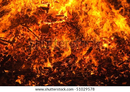 Photo of bright fire flames in darkness