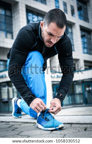 Similar – Foto Bild Seriöser Mann beim Schnüren von Stiefeletten