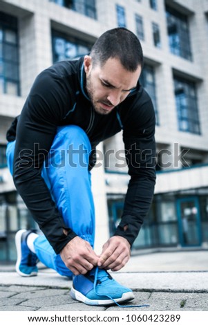 Similar – Foto Bild Seriöser Mann beim Schnüren von Stiefeletten