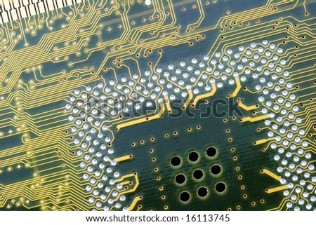 An photo of the back side of yellow computer mother board.
