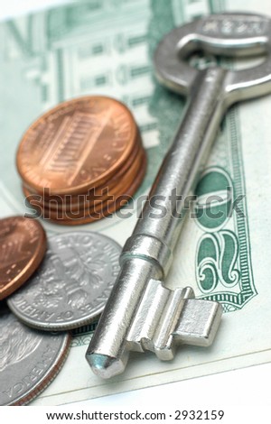 Key with US dollar and coins. Low DOF
