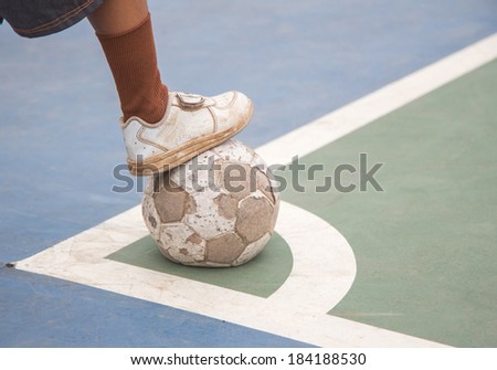 Boy is holding a football,old football,old shoe