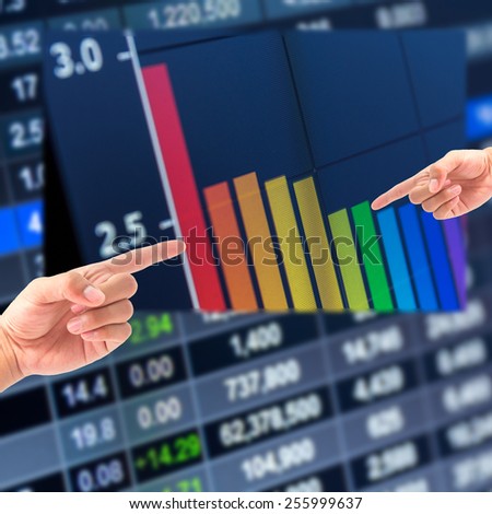 Hand and stock graph,Stock market chart,Stock market data on LED display concept
