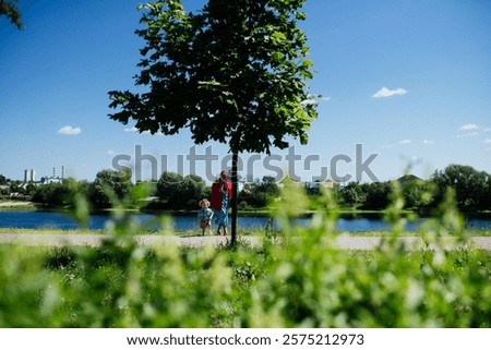 Similar – Image, Stock Photo Child stands under a pepper tree in the sun