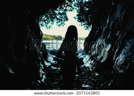 
A girl enters to explore a cave in one of the beaches near Juanchaco in the Colombian Pacific.Bahía Malaga, Colombia Photo stock © 