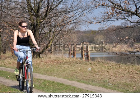 Girl riding a bike in beautiful spring scenery
