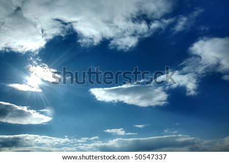 Beautiful blue sky with shining sun and many white clouds