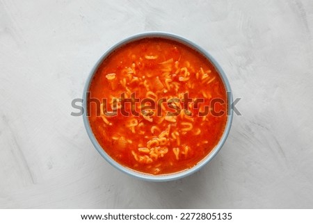 Similar – Image, Stock Photo spoon with letters soup noodles in a white soup plate next to semolina gnocchi and carrot german text hair