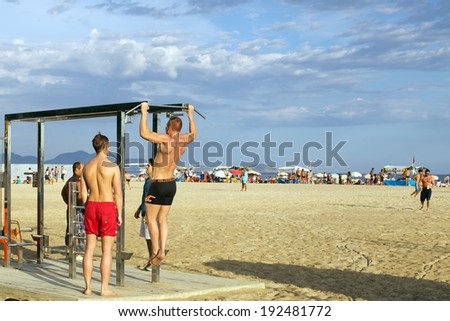 RIO DE JANEIRO, DECEMBER 30, 2013 - Gym station with sportsmen on copacabana Beach