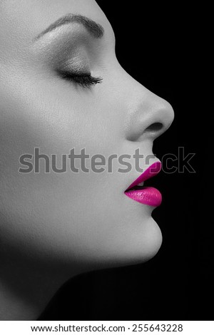 Beauty Close-up Portrait of Beautiful Sexy Woman Model with Fashion Eyes Make-up and Pink Lips on Black Background
