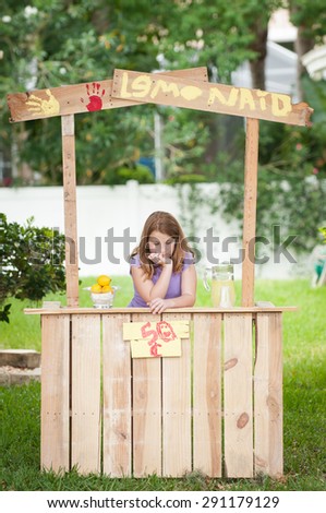 Bored young girl with no customers at her lemonade stand