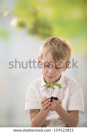 young boy with a small oak in his hands