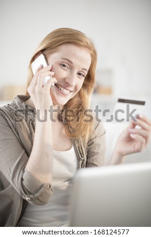 young woman at phone paying online ordering