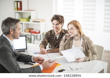 real-estate agent receives a young couple interested to invest in an house