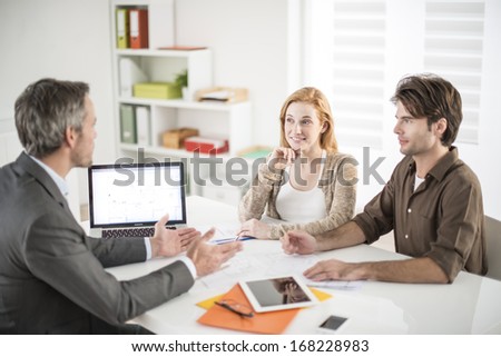 real-estate agent receives a young couple interested to invest in an house