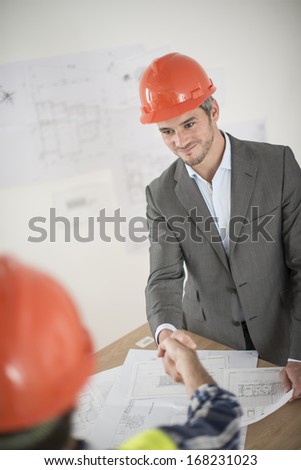 handshake during a meeting about a build project