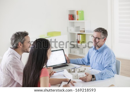 Young couple meeting construction planner