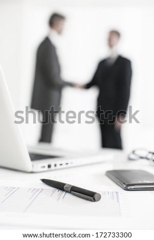 silhouette of a business people  with symbolic business objects in the foreground