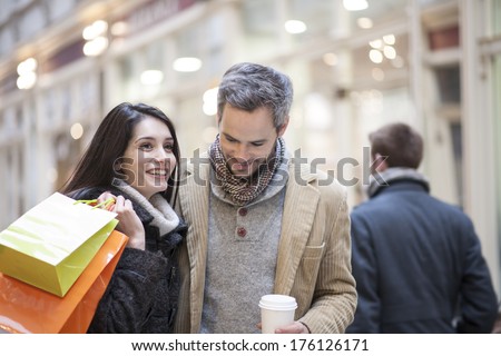 handsome couple doing shopping city lights in the background