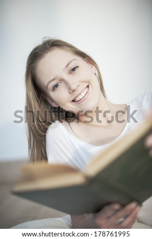 closeup of a beautiful young woman reading a book