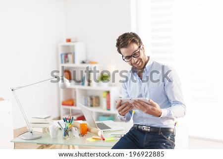 young man using a digital tablet at office