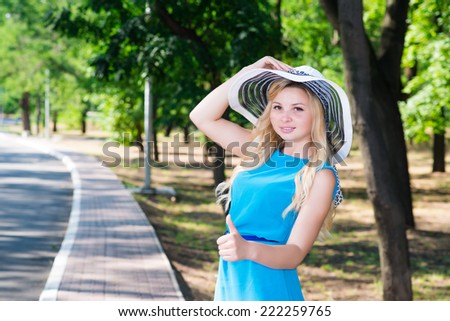 beautiful young woman in hat park