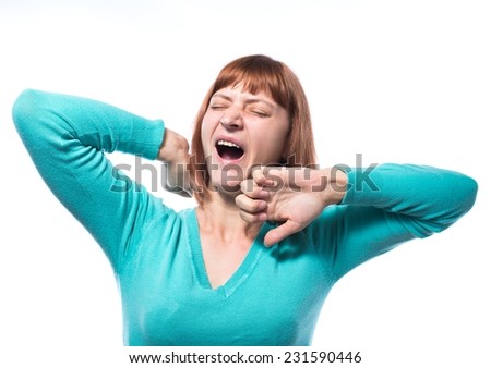 standing beautiful woman in brown blouse, yawning and stretching