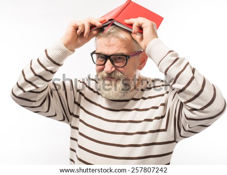 old man with a book on her head