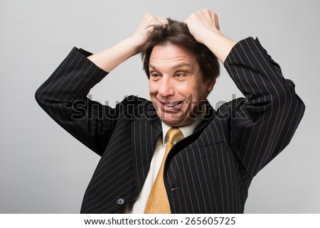 man holding his hands on his head stress