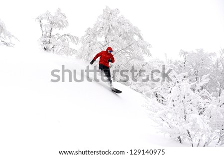 Man snowboarding down the mountain