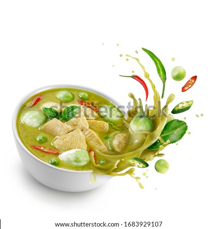 Thai food chicken green curry isolated on white background ,sliced chicken beast fillets, quartered eggplants, pea eggplant, basil leaves ,Kaffir lime leaves and pepper Splash on the air.
