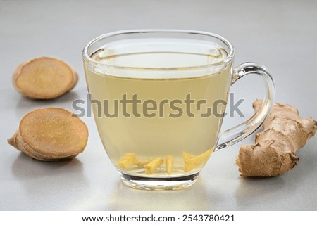 Similar – Image, Stock Photo Glass cup with ginger and lemon tea, on a yellow background along with its ingredients.