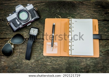 Notebook mock up for artwork or logo design presentation with film camera and lens. View from above vintage colors
