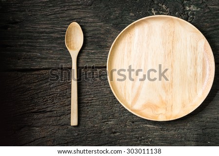 wood dish and spoon on old wood table. Concept How to lose weight still-lift
