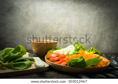 salad on wood dish w on the old wood table concept the fat that comes from food still-lift