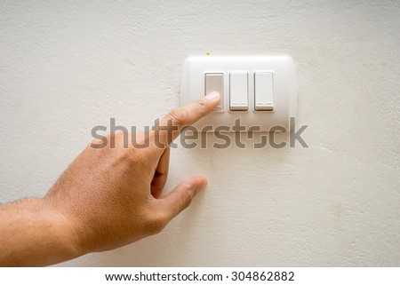 hand pressing electronic-light switch