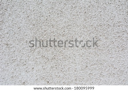 Rough white concrete wall texture as background.