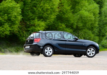 MINSK - JULY 2015: new BMW 1-series 2015 drives along the road during the test drive event for automotive journalists from Minsk