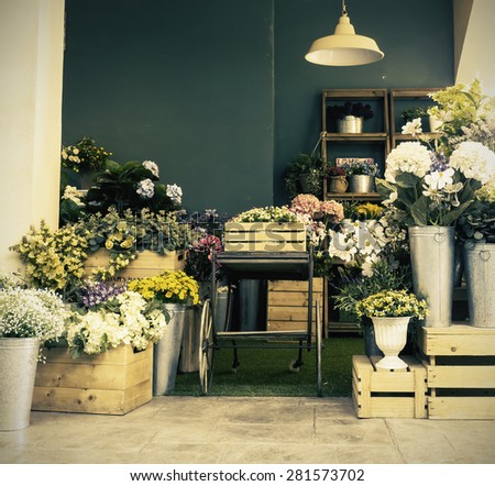 Beautiful  decoration of garden with flower box and pot plants in twilight ( Vintage tone color- Space on the wall for text)