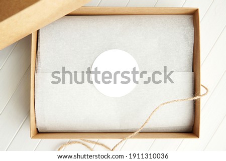 Round sticker mockup, circle white adhesive label in brown gift box. Stock foto © 