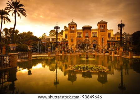 Mudejar Pavilion and pond at sunset. Placed in the Plaza de America, houses the Museum of Arts and Traditions of Sevilla, Spain. Built in 1928 for the Ibero-American Exposition of 1929