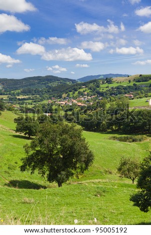 Cantabria landscape, typical valley with little town rounded by pastures and trees. Spain