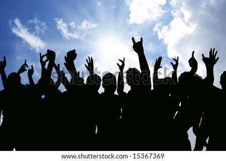 Silhouettes of an excited audience outside