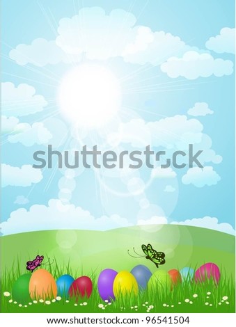 Easter eggs in grass in a sunny landscape