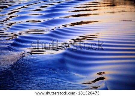 Ripples In The Wake Of A Pontoon Boat At Sunset On Whitewood Lake, Part Of The Huron River Chain Of Lakes, Southeastern Michigan, USA