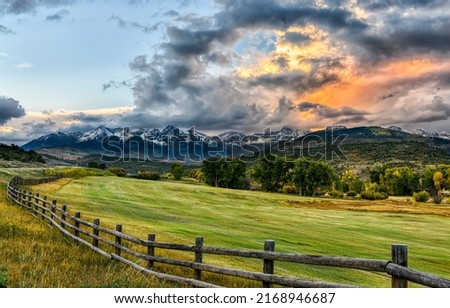 Wooden fence around an pasture field in a mountain valley. Pasture fence. Pasture wooden fence. Fence on pasture Foto d'archivio © 