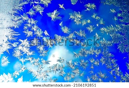 Frozen glass with snowflakes background. Winter Christmas background