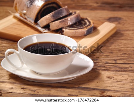 coffee and poppy seed cake on wooden table