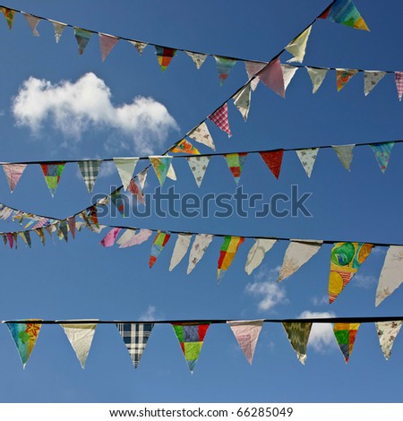 Bunting Flags Blowing in the Wind Against A Blue Sky