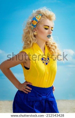Portrait of blonde ukrainian girl in yellow and blue clothes